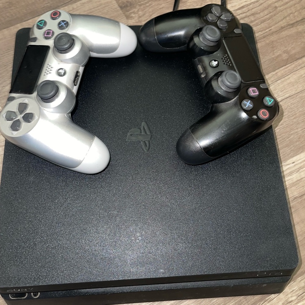 Sony PlayStation Console with Black and Silver Controllers